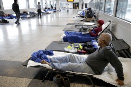 Cots line a hallway where stranded travelers slept at LaGuardia Airport in New York, Tuesday, Jan. 27, 2015. A storm packing blizzard conditions spun up the East Coast early Tuesday, pounding parts of coastal New Jersey northward through Maine with high winds and heavy snow. (AP Photo/Seth Wenig)