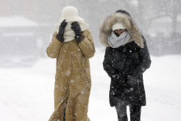Pedestrians walk bundled against the blowing snow during a winter snowstorm, Tuesday, Jan. 27, 2015, in Boston. A blizzard heaped snow on Boston, the rest of eastern Massachusetts and parts of Long Island on Tuesday, delivering wind gusts topping 75 mph, but it failed to live up to the hype farther south in Philadelphia and New York City. (AP Photo/Steven Senne)