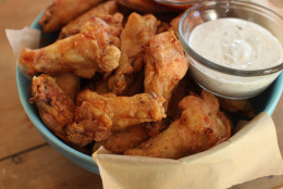 This Nov. 16, 2015 photo shows hands off party wings with cilantro sour cream dip and honey sriracha in Concord, N.H. These wings require almost no effort from you. The secret is baking powder. The baking powder reacts with the skin, helping to draw out moisture. (AP Photo/Matthew Mead)