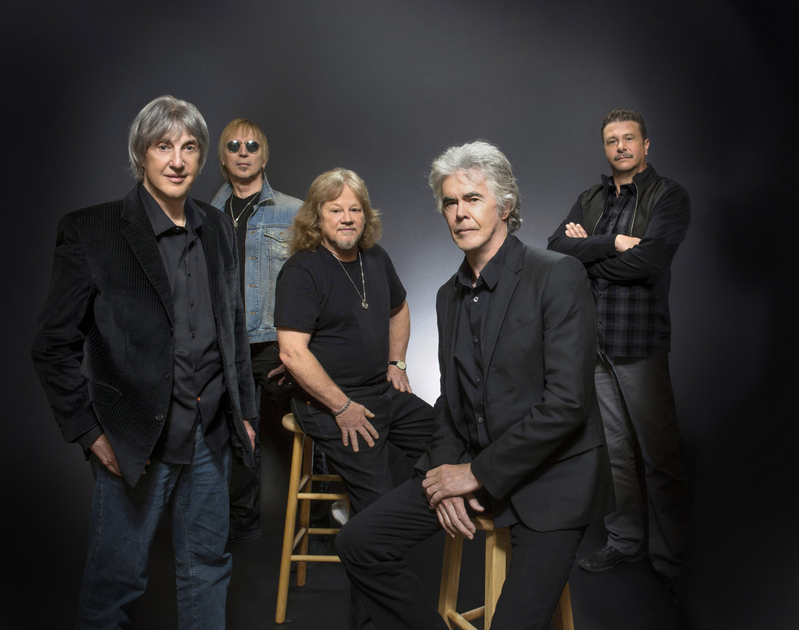 This June 2014 photo provided by Three Dog Night shows, band members, Cory Wells, from left, Paul Kingery, Michael Allsup, Danny Hutton, and Pat Bautz of the music group, Three Dog Night, posing for a portrait, in Las Vegas. Wells, a founding member of the popular 1970s band and lead singer on such hits as "Never Been to Spain" and "Mama Told Me (Not to Come)," has died at age 74. Wells, pictured in the forefront, experienced acute back pain weeks ago and died suddenly Tuesday, Oct. 20, 2015, in Dunkirk, where he had lived, bandmate Hutton said.  (Steve Spatafore/Three Dog Night via AP)