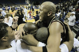 Indiana-Purdue-Indianapolis' Odell Bradley celebrates with teammates following the championship game of the Mid-Continent Conference Men's Basketball Tournament, Kansas City, Mo., Tuesday, March 11, 2003. IUPUI beat Valparaiso 66-64.(AP Photo/Dick Whipple).