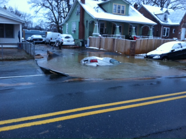 car in water main sinkhole