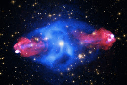 This galaxy, at a distance of some 700 million light years, contains a giant bubble filled with hot, X-ray emitting gas detected by Chandra (blue). Radio data from the NSF's Very Large Array (red) reveal "hot spots" about 300,000 light years out from the center of the galaxy where powerful jets emanating from the galaxy's supermassive black hole end. Visible light data (yellow) from both Hubble and the DSS complete this view. 
(Captions and images -  X-ray: NASA/CXC/SAO; Optical: NASA/STScI; Radio: NSF/NRAO/AUI/VLA)