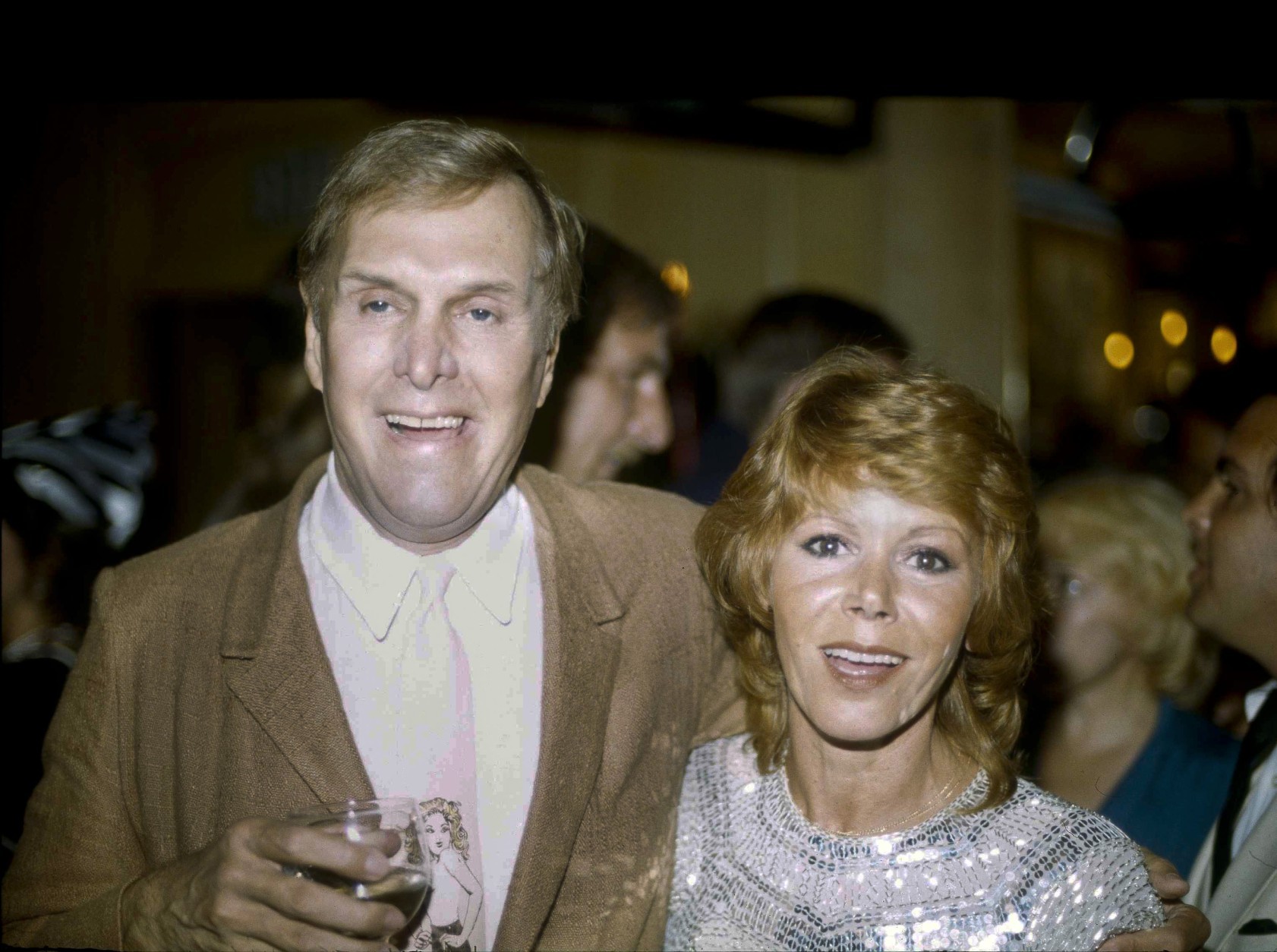 FILE - In this Tuesday, Sept. 13, 1983 file photo, actors Judy Carne and Alan Sues, left, of "Rowan And Martin's Laugh-In" are shown during a "Laugh-In" reunion party, in Los Angeles. Laugh-In star Judy Carne has died in a British hospital. She was 76. She was famous for popularizing the Sock it to Me phrase on the hit TV show that started in the late 1960s. Her death was confirmed Tuesday, Sept. 8, 2015 in an e-mail by Eva Duffy, spokeswoman for Northampton General Hospital. Duffy said Carne died in the hospital on September 3. Newspaper reports said she had suffered from pneumonia. (AP Photo/Doug Pizac, file)