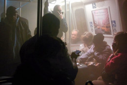 Smoke fills a Washington Metro system subway car near the L'Enfant Plaza station in Washington, Monday, Jan. 12, 2015. An electrical malfunction that filled the busy subway station with smoke killed one woman and sent dozens of people to hospitals. (AP Photo/Andrew Litwin)