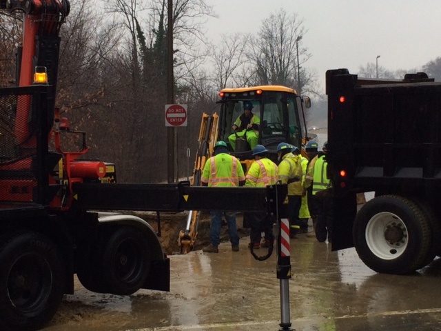 Men work to repair a water main break that occurred early Monday in Arlington on U.S. 29 at the bottom of the ramp from eastbound I-66 eastbound to Spout Run.  (WTOP/Rob Stallworth)