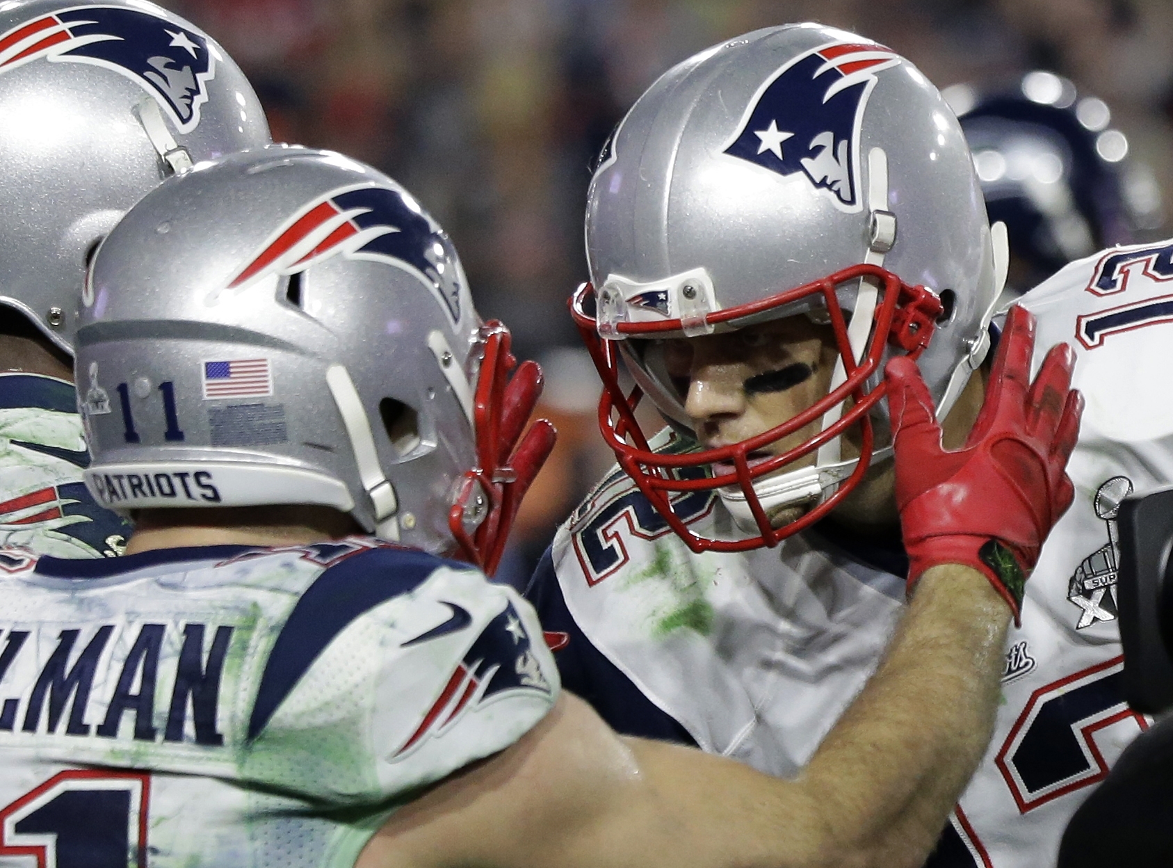 New England Patriots wide receiver Julian Edelman (11) celebrates with Tom Brady after catching a three-yard touchdown pass during the second half of NFL Super Bowl XLIX football game against the Seattle Seahawks Sunday, Feb. 1, 2015, in Glendale, Ariz. (AP Photo/David Goldman)
