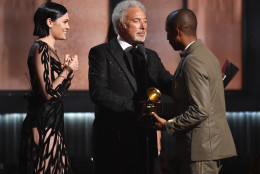 Jessie J, left, and Tom Jones present the award for best pop solo performance to Pharrell Williams, right, for "Happy" at the 57th annual Grammy Awards on Sunday, Feb. 8, 2015, in Los Angeles. (Photo by John Shearer/Invision/AP)