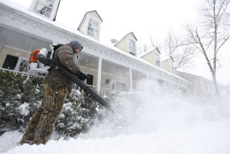 Breck Gorman of Richmond, Va., clears  the walkway in front of his home with a blower during a snowstorm in Richmond, Va., Thursday, Feb. 26, 2015. The Richmond area received about 4-6 inches of snow. (AP Photo/Steve Helber)
