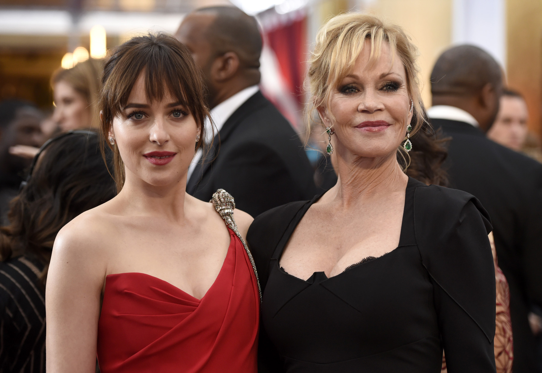 Dakota Johnson, left, and Melanie Griffith arrive at the Oscars on Sunday, Feb. 22, 2015, at the Dolby Theatre in Los Angeles. (Photo by Chris Pizzello/Invision/AP)