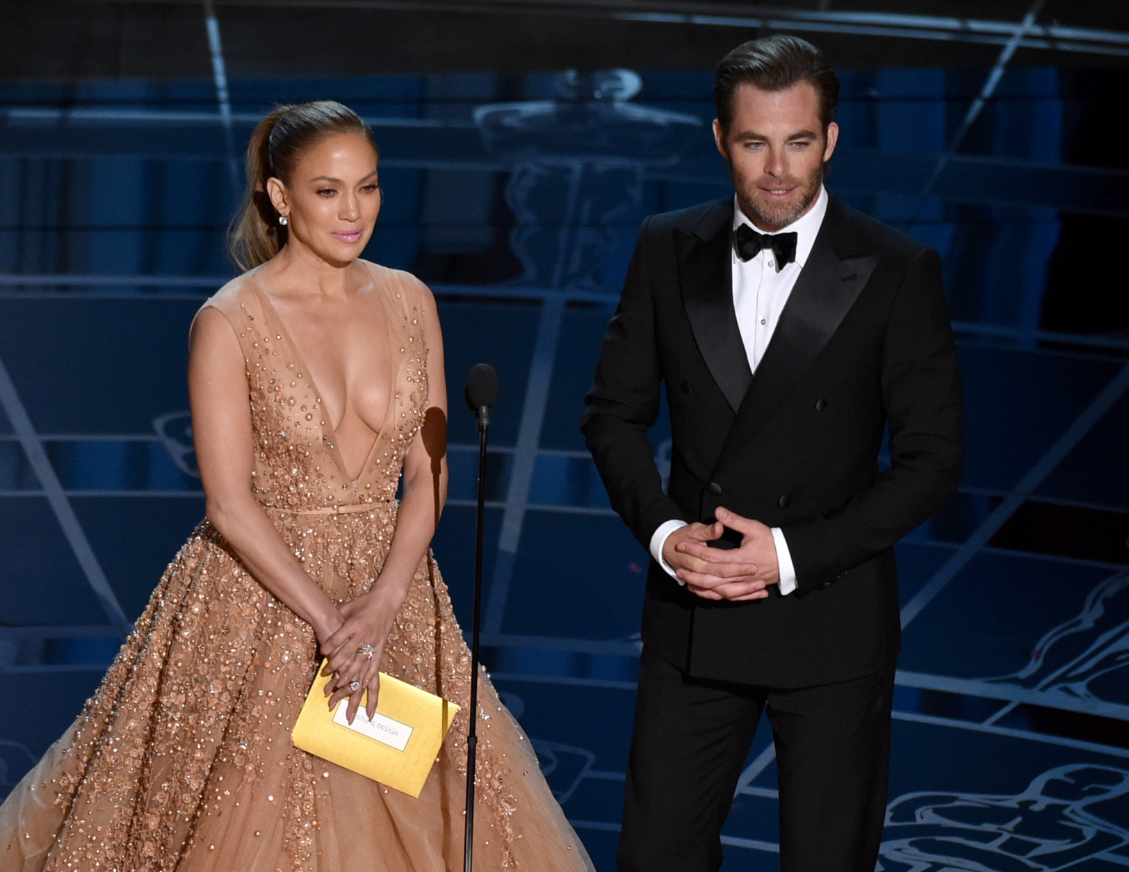 Jennifer Lopez, left, and Chris Pine present the award for best costume design at the Oscars on Sunday, Feb. 22, 2015, at the Dolby Theatre in Los Angeles. (Photo by John Shearer/Invision/AP)