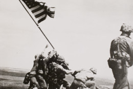 This black-and-white image provided by the National Archives shows a "still" taken from the 16 mm movie series of Marines raising the American flag on the summit of Mount Suribachi, on Iwo Jima. (AP Photo/Files/William H. Genaust)