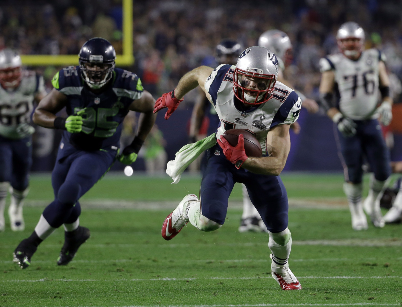 New England Patriots wide receiver Julian Edelman (11) runs during the second half of NFL Super Bowl XLIX football game against the Seattle Seahawks Sunday, Feb. 1, 2015, in Glendale, Ariz. (AP Photo/Mark Humphrey)