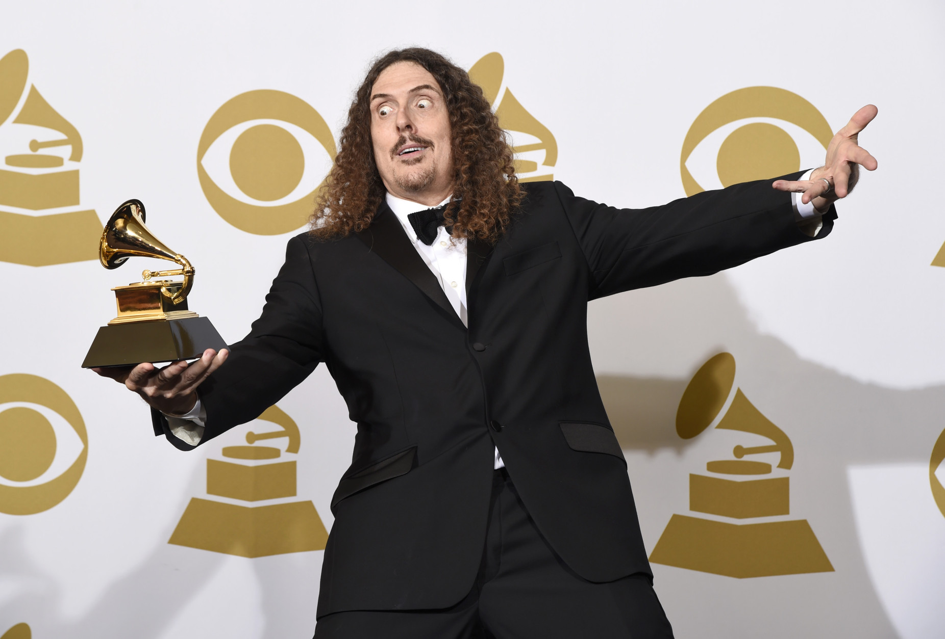 "Weird Al" Yankovic poses in the press room with the award for best comedy album for "Mandatory Fun" at the 57th annual Grammy Awards at the Staples Center on Sunday, Feb. 8, 2015, in Los Angeles. (Photo by Chris Pizzello/Invision/AP)