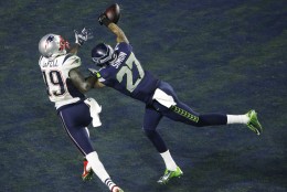 Seattle Seahawks cornerback Tharold Simon (27) breaks up a pass intended for New England Patriots wide receiver Brandon LaFell (19) during the second half of NFL Super Bowl XLIX football game Sunday, Feb. 1, 2015, in Glendale, Ariz.  (AP Photo/Charlie Riedel)
