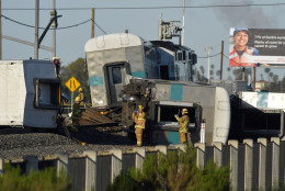 Firefighter stand in front of the wreck of a Metrolink passenger train that derailed, Tuesday, Feb. 24, 2015, in Oxnard, Calif. Three cars of the Metrolink train tumbled onto their sides, injuring dozens of people in agricultural country 65 miles northwest of Los Angeles. Metrolink spokesman Scott Johnson told the Los Angeles Times that at least 30 people were injured. (AP Photo/Mark J. Terrill)