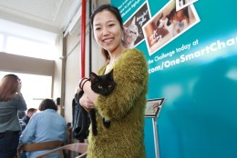 IMAGE DISTRIBUTED FOR PURINA ONE - Yizi Chen prepares to take Ciarra, her newly adopted cat, home during the adoption drive taking place at the Cat Cafe by Purina ONE on Sunday, April 27, 2014, in New York. (Photo by Amy Sussman/Invision for Purina ONE/AP Images)