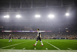 New England Patriots quarterback Tom Brady (12) walks on the field during halftime of NFL Super Bowl XLIX football game against the Seattle Seahawks Sunday, Feb. 1, 2015, in Glendale, Ariz. (AP Photo/Patrick Semansky)