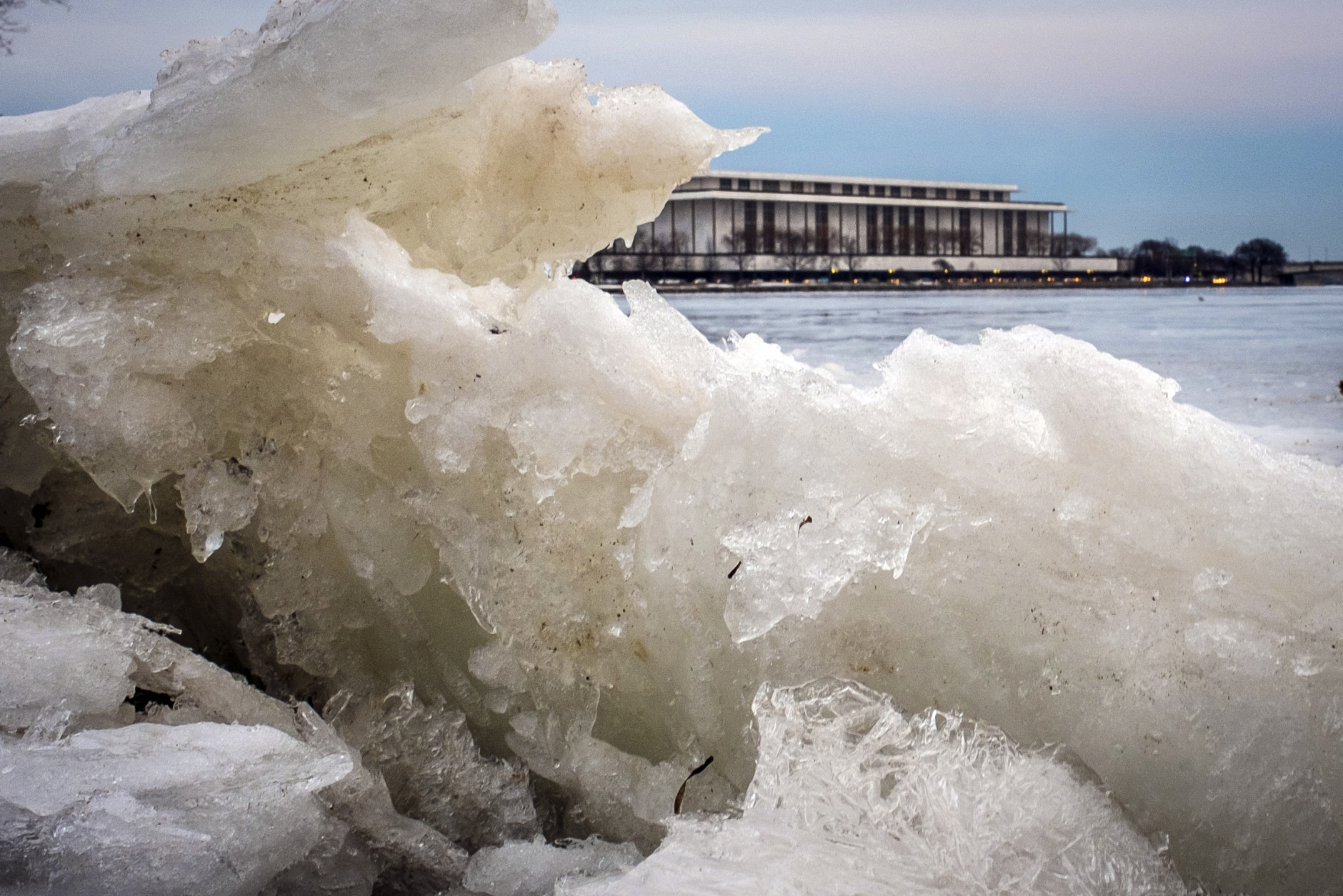 The Kennedy Center for the Performing Arts is framed in the ice along the edge of the Potomac River in Washington, Wednesday evening, Feb. 25, 2015. The Nation's Capitol hasn't thawed out from the last winter weather blast as a new front heads toward the area overnight. (AP Photo/J. David Ake)