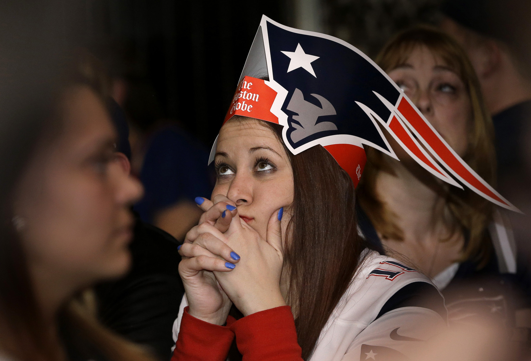 Courtney Lurate, of Boston, watches the New England Patriots play against the Seattle Seahawks in the NFL Super Bowl XLIX football game in Glendale, Ariz., Sunday, Feb. 1, 2015, at a bar in Boston. (AP Photo/Steven Senne)