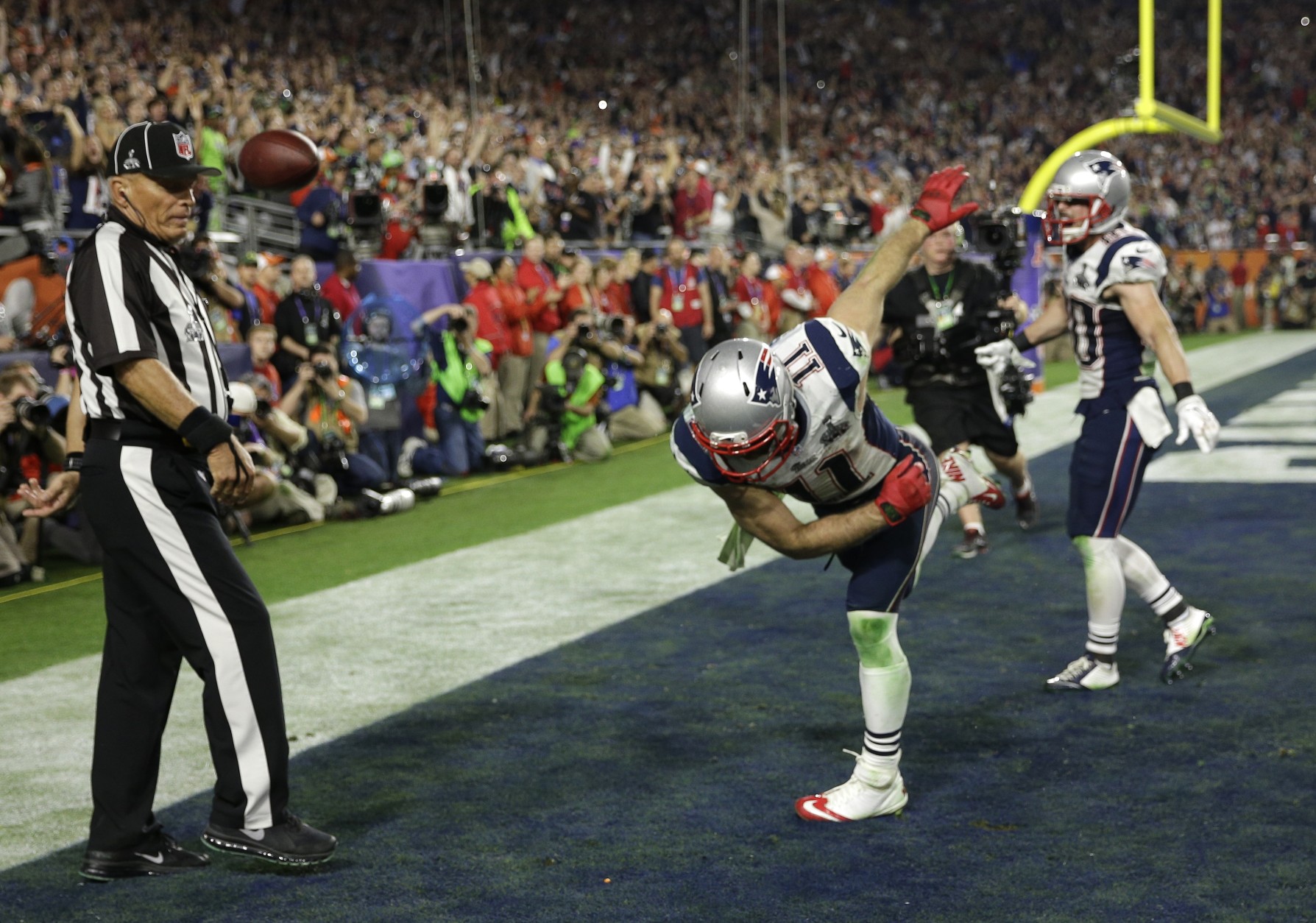 New England Patriots wide receiver Julian Edelman (11) spikes the ball after catching a three-yard touchdown pass during the second half of NFL Super Bowl XLIX football game against the Seattle Seahawks Sunday, Feb. 1, 2015, in Glendale, Ariz. (AP Photo/David J. Phillip)