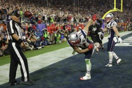 New England Patriots wide receiver Julian Edelman (11) spikes the ball after catching a three-yard touchdown pass during the second half of NFL Super Bowl XLIX football game against the Seattle Seahawks Sunday, Feb. 1, 2015, in Glendale, Ariz. (AP Photo/David J. Phillip)