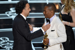 Eddie Murphy, right, presents Alejandro G. Inarritu with the award for the best original screenplay for “Birdman or (The Unexpected Virtue of Ignorance)” at the Oscars on Sunday, Feb. 22, 2015, at the Dolby Theatre in Los Angeles. (Photo by John Shearer/Invision/AP)