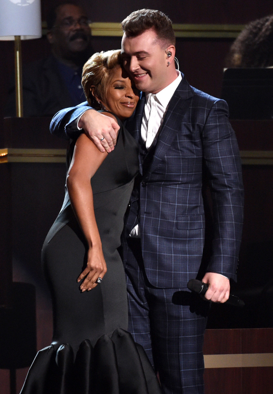 Mary J. Blige, left, and Sam Smith embrace at the 57th annual Grammy Awards on Sunday, Feb. 8, 2015, in Los Angeles. (Photo by John Shearer/Invision/AP)