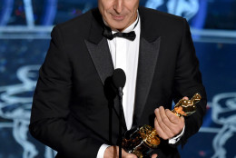 Alexandre Desplat accepts the award for original score in a feature film for “The Grand Budapest Hotel” at the Oscars on Sunday, Feb. 22, 2015, at the Dolby Theatre in Los Angeles. (Photo by John Shearer/Invision/AP)