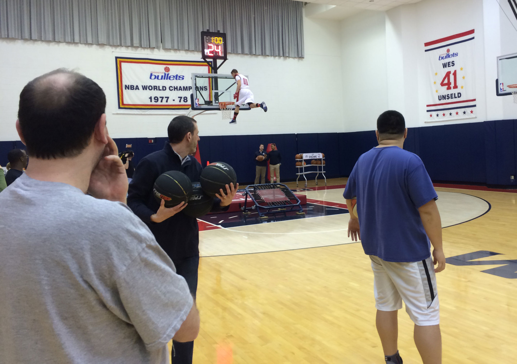 The event culminated with the dunk contest, performed off a trampoline. Wizards employees showed us how (we were supposed) to do it. (WTOP/Noah Frank)