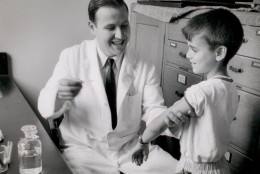Here, Dr. Samuel Katz injects one of his sons with the measles vaccine.