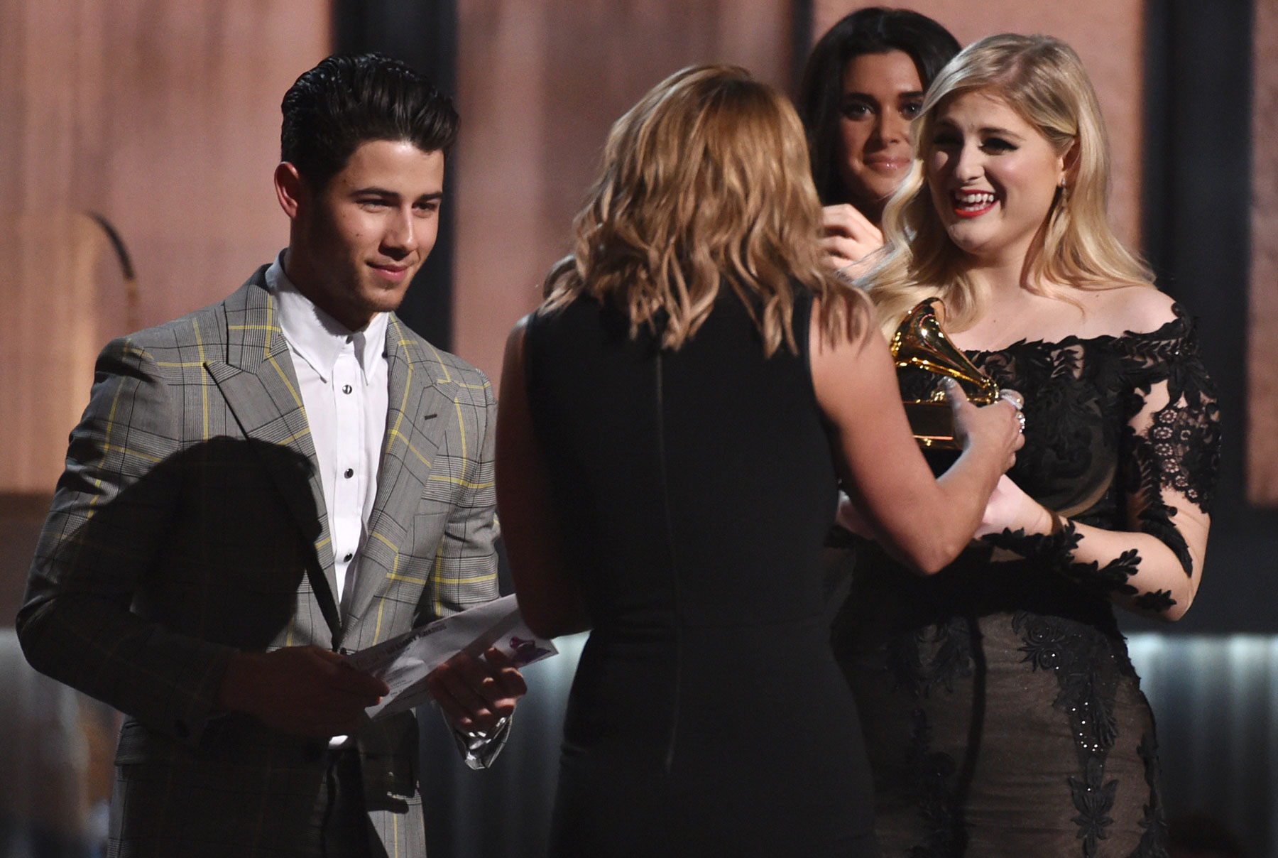 Nick Jonas, left, and Meghan Trainor, right, present Miranda Lambert with the award for best country album for “Platinum” at the 57th annual Grammy Awards on Sunday, Feb. 8, 2015, in Los Angeles. (Photo by John Shearer/Invision/AP)