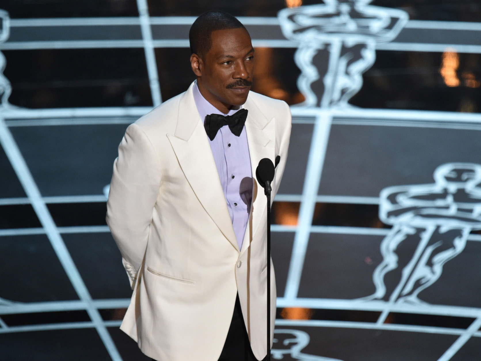 Eddie Murphy presents the award for best original screenplay at the Oscars on Sunday, Feb. 22, 2015, at the Dolby Theatre in Los Angeles. (Photo by John Shearer/Invision/AP)