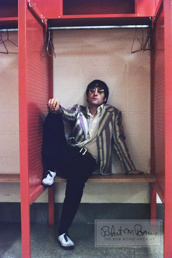 Amidst hangers and locker cubbies, John Lennon lounges backstage before the Beatles’ show at Busch Memorial Stadium in St. Louis, Missouri, on August 21, 1966. These few moments of peace turned out to be fleeting, as once the Beatles took the stage, they were pummeled with a downpour. Though the venue had constructed a makeshift shelter out of slivers of corrugated iron, rain still dripped on the amps and created a downright soggy attitude in the band. Paul McCartney called the show “worse than those early days” at the Cavern Club, one of the very reasons he finally agreed with the others to stop touring forever. So the 23,000 fans in attendance were amongst the last to see The Beatles on tour as they played only four more shows before retiring from touring and live performances, although London guests at the January 30, 1969, rooftop show at Apple Records headquarters have the distinction of being the last to ever see the fab four perform live. 
