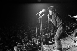 Mick Jagger sings his heart out to adoring German fans during the Stones’ controversial West Berlin show at the Waldbuhne on September 15, 1965. The Stones rocked the outdoor amphitheater - built during the Third Reich by Propaganda Minister Joseph Goebbels as part of the 1936 Olympic complex and was a place where Hitler had made some of his famous speeches - but not for long. A riot broke out after the first song and the Stones had to retreat to the underground bunkers for protection.  After the police got things under control the Stones went back on stage and finished out their set.  The real riot and damage happened after the Stones left.  What came next was ugly: riots broke out and police turned rubber truncheons and fire hoses on the crowd, who destroyed the venue to the tune of 270,000 deutsche marks. The final aftermath tallied 85 arrests, 87 injured and 17 ransacked S-Bahn trains - which prompted East Berlin to use the incident as anti-West propaganda. Officials declared, “These songs are straight from the madhouse.” But a Bild Zeitung reporter summed it up the show best: “I know Hell.” This photograph, quite literally, depicts the calm before the rock ‘n’ roll storm.