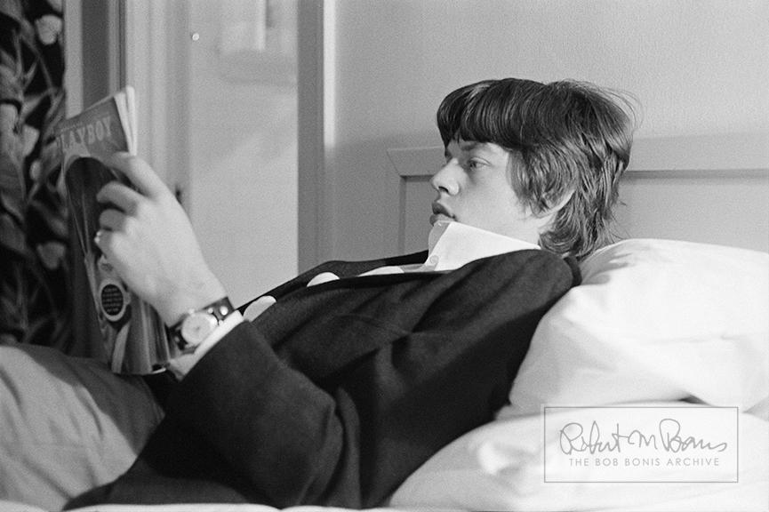 Life on the road can get lonely and even a bit mundane after the high of a live performance. In the spring of 1965, the Rolling Stones stayed in L.A. for several concert performances, TV appearances (including Hollywood A Go Go and Shindig), and recording sessions at RCA Studios. Here Mick Jagger takes advantage of a little downtime to catch up on the June 1965 issue of Playboy magazine, perhaps reviewing the first ever nude pictorial spread of James Bond Girl Ursula Andress.  

Four years later, Mick went from fan boy to main man when he was profiled in the November 1969 issue. The Stones would later stay in the Playboy Mansion in Chicago - at Hugh Hefner’s personal invitation - because hotel rooms were scarce during their 1972 US tour (an invite Hefner likely regretted after Keith Richards and Bobby Keys accidentally set fire to one of his bathrooms). And in perhaps the strangest twist, 46 years to the month after reading this very issue of Playboy, Mick’s daughter Lizzy would bare all for the June 2011 issue.