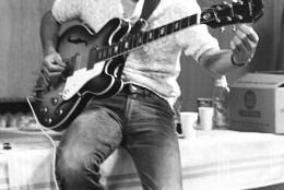 Perched on a craft service table, George Harrison tunes his guitar for the Beatles’ performance that night at JFK Stadium (formerly Philadelphia Municipal Stadium) in Philadelphia, Pennsylvania, on August 16, 1966. George’s guitar - an Epiphone Casino, with an aftermarket Bigsby Vibrato, that he acquired in the spring of 1966 - was in the studio for their album Revolver and the single Paperback Writer/Rain, as well as on tour with them all over the world in 1966. John Lennon had one too, although his had the standard Epiphone tailpiece, the back of which he spray-painted, and which would become his guitar of choice until the end of the Beatles. Not many people know that George played a myriad of instruments - 26 in all - and was the very first to introduce the sitar to the pop world in Norwegian Wood, beating The Rolling Stones’ Paint It Black by a full year.