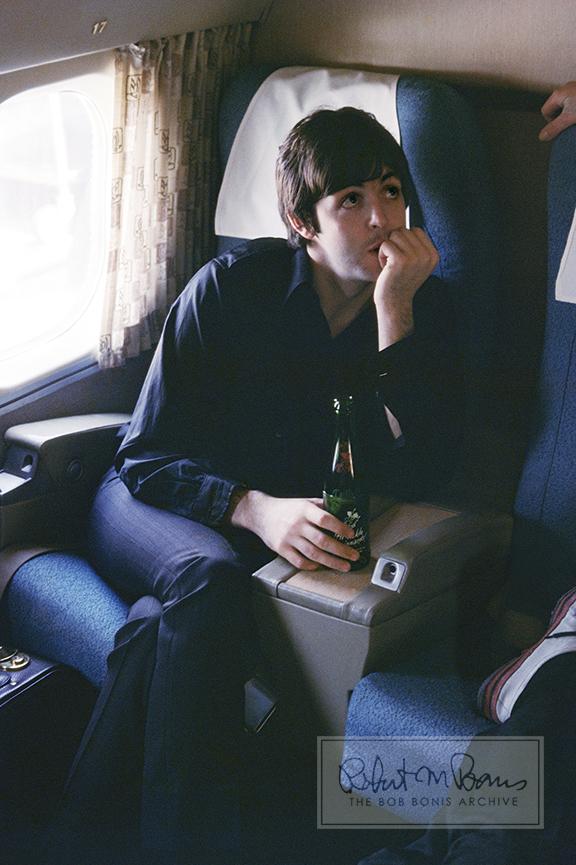 In a rare moment of downtime, Paul McCartney listens intently to an unidentified friend while riding in an airplane. Earlier that day, the Beatles had played an afternoon concert at Crosley Field in Cincinnati, Ohio, because their scheduled show on August 20 had been a complete washout. After their final number, the Beatles and the other acts booked it to Boone County Airport in Kentucky for a quick puddle jumper to St. Louis for their Busch Memorial Stadium show that night. George Harrison recalls the chaos: “We had to get up early and get on and play the concert at midday, then take all the gear apart and go to the airport, fly to St. Louis, set up and play the gig originally planned for that day. In those days all we had were three amps, three guitars and a set of drums. Imagine trying to do it now!” As it turns out, August 21, 1966, would be the only day in Beatles US tour history that the boys played two cities on the same day.