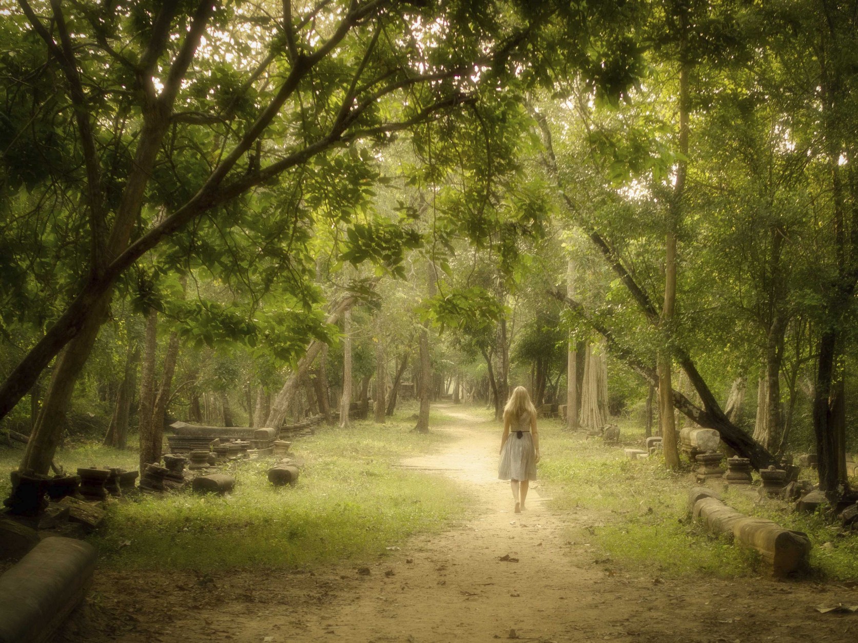 Young Woman Walking on Path into Enchanted Forest