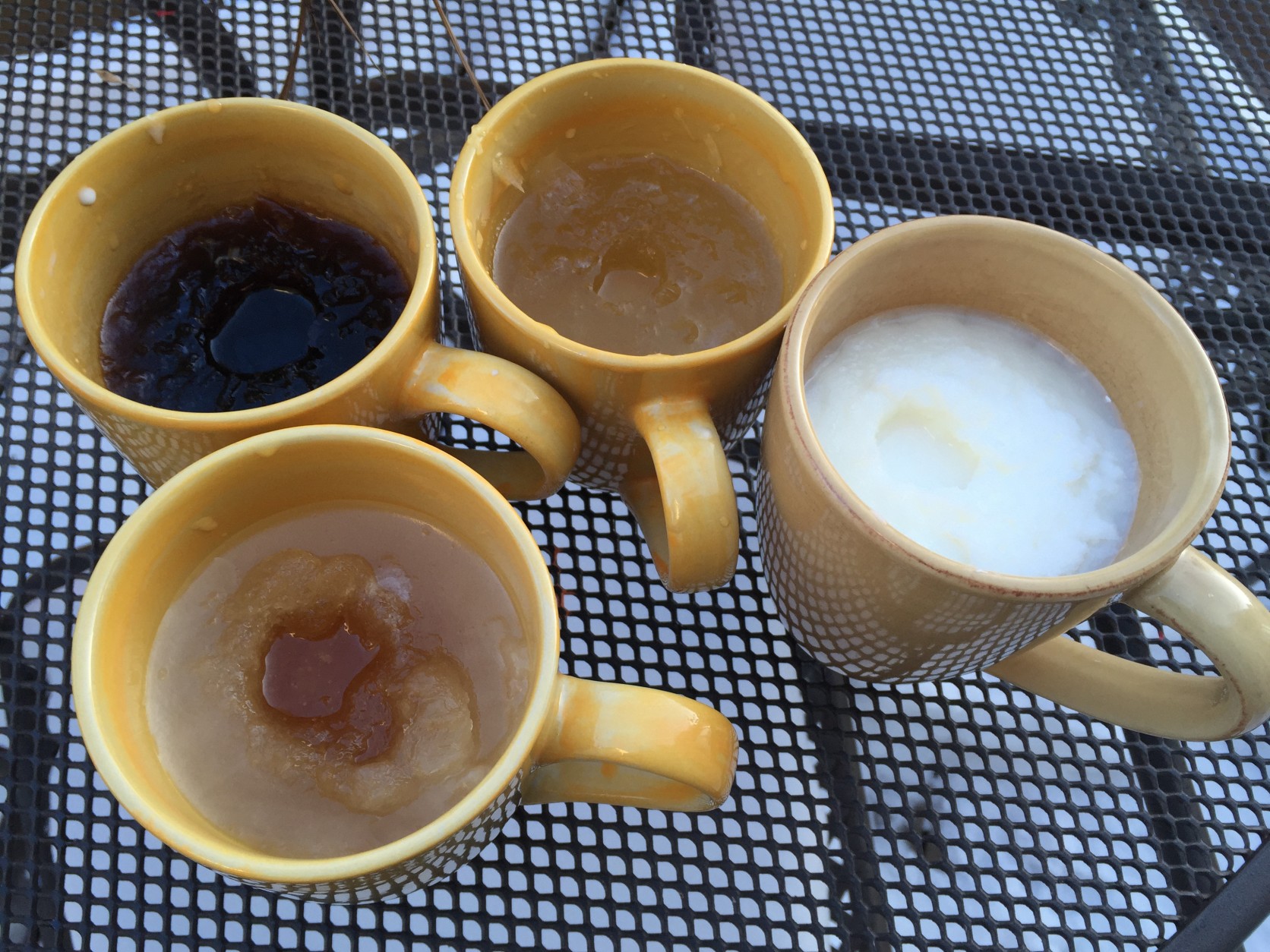 Two hours and 30 minutes after being left in 10 degree temperatures, all four drinks have some ice, but none is frozen solid. (WTOP/Neal Augenstein)