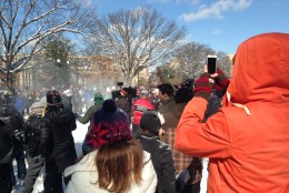 Nick Davis takes a video of the mayhem in Meridian Hill Park as the snowball fight was underway. Davis, from Iowa, says the snow could be wetter to make better snowballs, but it doesn't seem to be hampering the fun. (WTOP/Megan Cloherty)