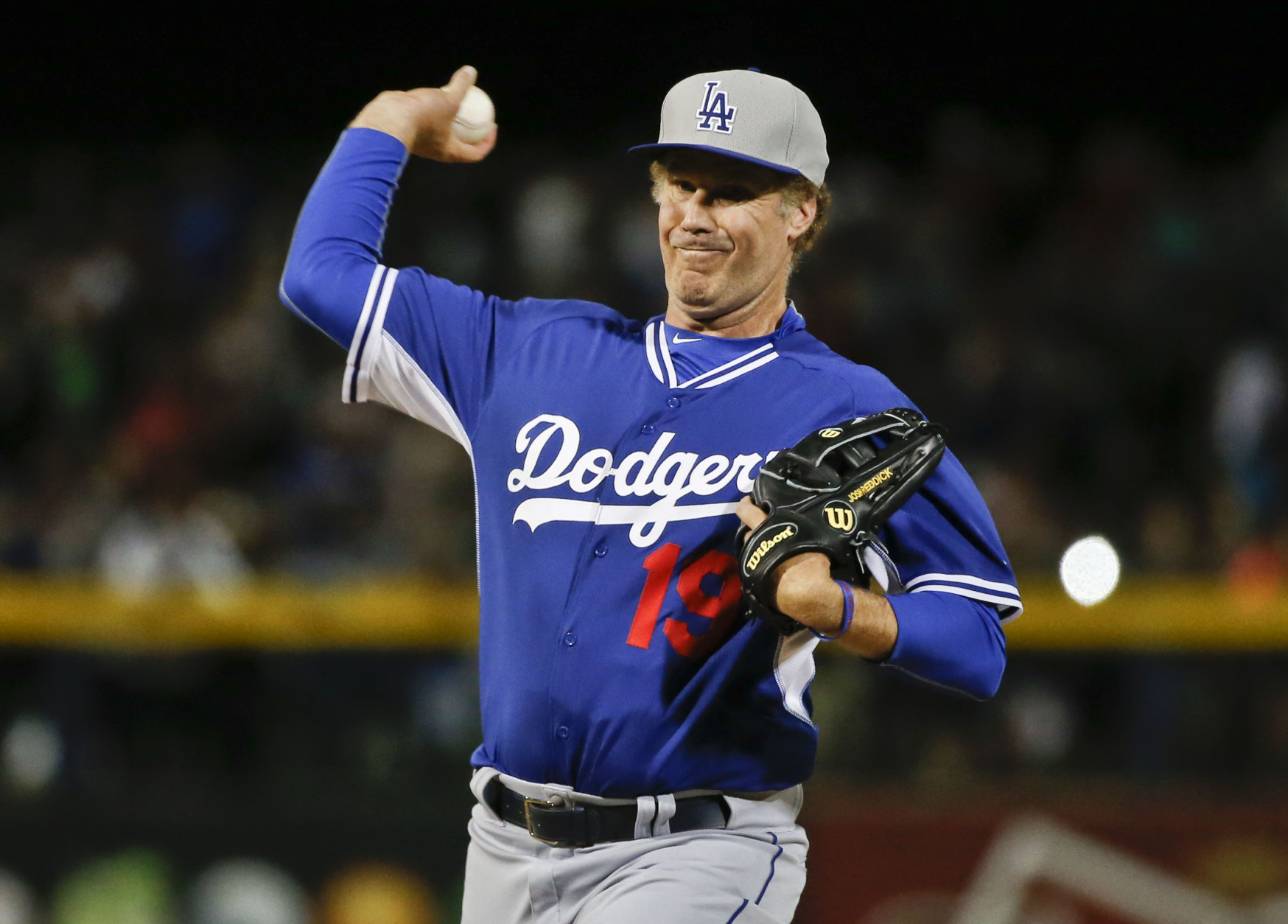 Actor Will Ferrell warms up for his pitching stint for the Los Angeles Dodgers during a spring training baseball game between the San Diego Padres and the Los Angeles Dodgers Thursday, March 12, 2015, in Peoria, Ariz.  (AP Photo/Lenny Ignelzi)