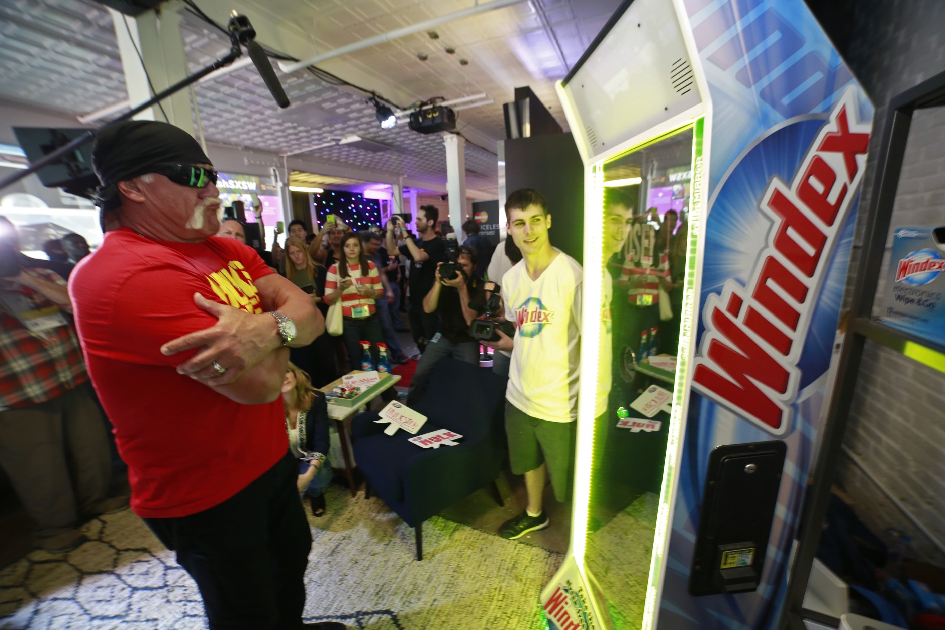 IMAGE DISTRIBUTED FOR WINDEX - WWE superstar, Hulk Hogan, center, poses for his official selfie at the Windex Selfie Mirror Station at Mashable House, during South by Southwest, Sunday, March 15, 2015, in Austin, Texas. (J. Michael Short/AP Images for Windex)