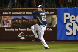 Actor Will Ferrell prepares to let go a throw from the outfield while playing right field for the San Diego Padres during a spring training baseball game against the Los Angeles Dodgers Thursday, March 12, 2015, in Peoria, Ariz.  (AP Photo/Lenny Ignelzi)