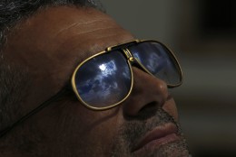 The solar  eclipse is reflected on the sunglasses of a man in  Nicosia, Cyprus, Friday, March 20, 2015. An eclipse is darkening parts of Europe on Friday in a rare solar event that won't be repeated for more than a decade. (AP Photo/Petros Karadjias)