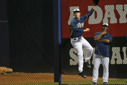 Actor Will Ferrell, playing right field for the San Diego Padres in a spring training baseball game, leaps at the right field fence long ax a home run by Los Angeles Dodgers' Joc Pederson cleared the fence by a wide margin Thursday, March 12, 2015, in Peoria, Ariz. (AP Photo/Lenny Ignelzi)