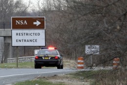 A Maryland State Police cruiser sits at a blocked southbound entrance on the Baltimore-Washington Parkway that accesses the National Security Agency, Monday, March 30, 2015, in Fort Meade, Md. A senior U.S. official says preliminary reports from the scene at Fort Meade indicate one person is dead after a car with two people tried to ram a gate at the base. The official says a firefight ensued after the car tried to crash the gate, and at least one of the two people in the car is dead. Fort Meade is home of the National Security Agency.  (AP Photo/Patrick Semansky)