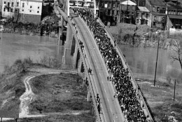 FILE - In this March 21, 1965 file photo, civil rights marchers cross the Alabama river on the Edmund Pettus Bridge in Selma, Ala. to the State Capitol of Montgomery. The Edmund Pettus Bridge gained instant immortality as a civil rights landmark when white police beat demonstrators marching for black voting rights 50 years ago this week in Selma, Alabama. Whats less known is that the bridge is named for a reputed leader of the early Ku Klux Klan. Now, a student group wants to rename the bridge that will be the backdrop when President Barack Obama visits Selma on March 7, 2015.  (AP Photo/File)