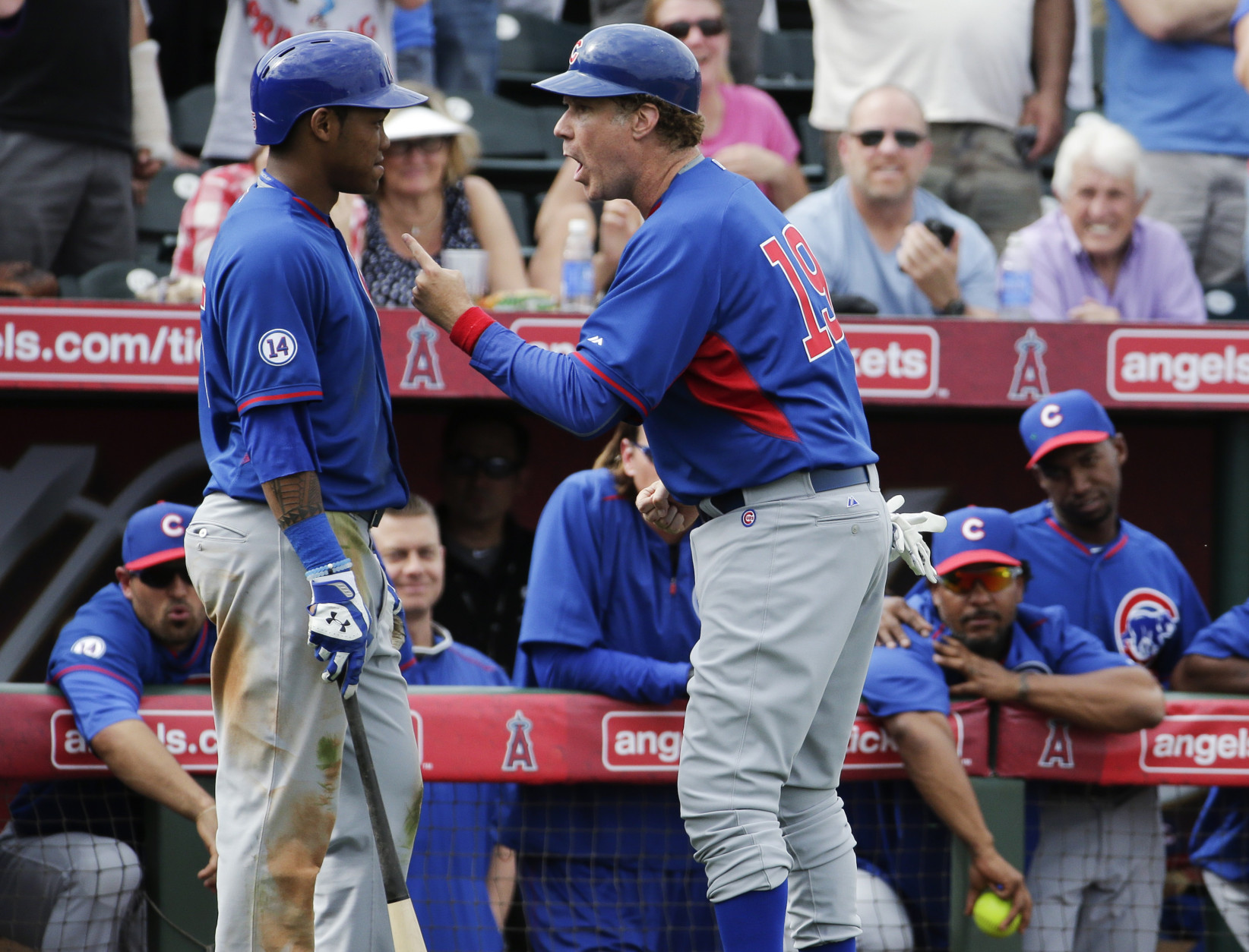 Actor Will Ferrell, acting as the third base coach, talks to Chicago Cubs' Addison Russell during the team's spring training baseball game against the Los Angeles Angels in Tempe, Ariz., on Thursday, March 12, 2015. (AP Photo/Chris Carlson)