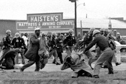 FILE - In this March 7, 1965 file photo, state troopers use clubs against participants of a civil rights voting march in Selma, Ala. At foreground right, John Lewis, chairman of the Student Nonviolent Coordinating Committee, is beaten by a state trooper. The day, which became known as "Bloody Sunday," is widely credited for galvanizing the nation's leaders and ultimately yielded passage of the Voting Rights Act of 1965. (AP Photo/File)